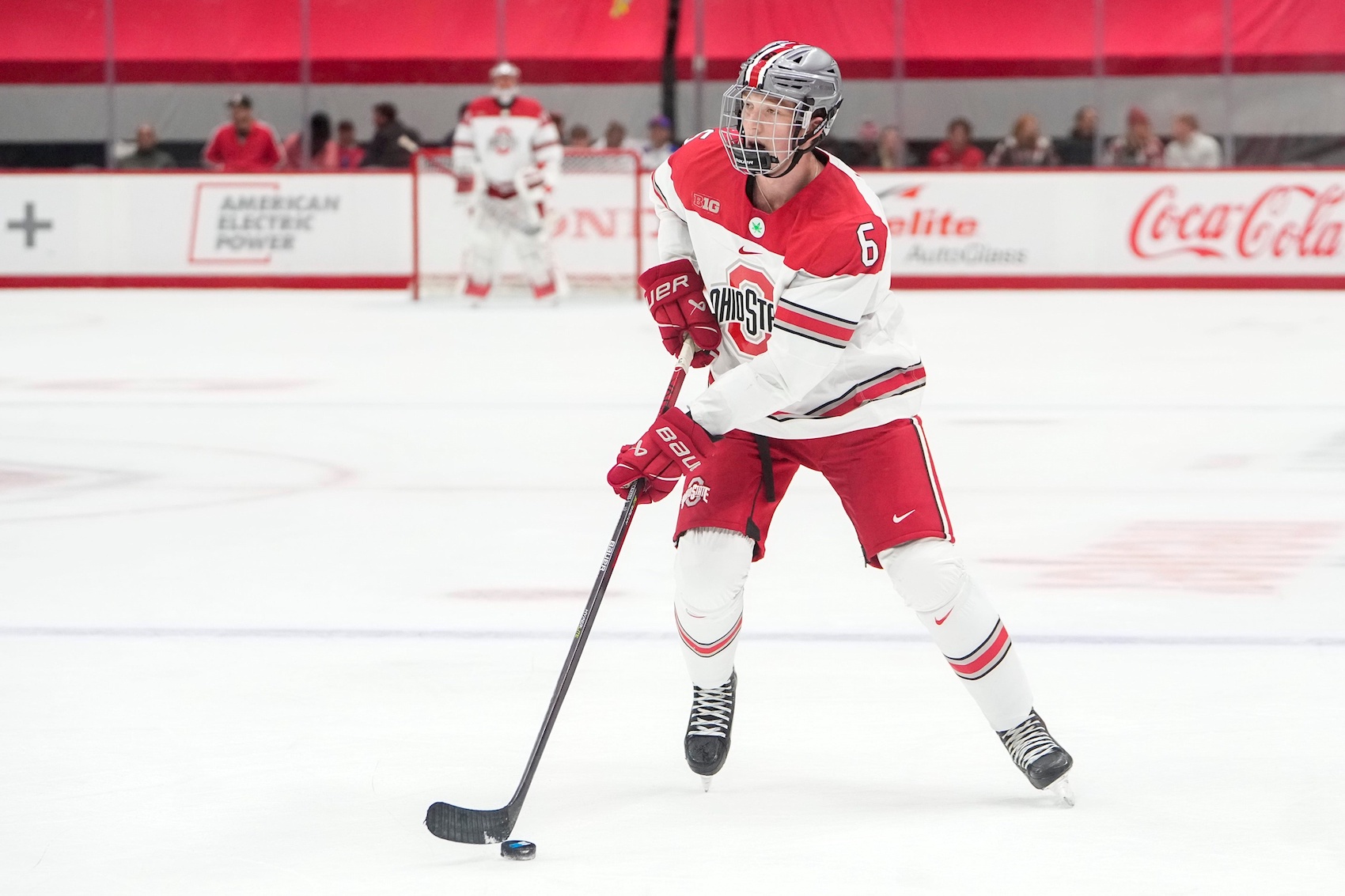 Oct 7, 2022; Columbus, Ohio, USA; Ohio State Buckeyes defenseman Mason Lohrei (6) brings the puck up ice during the NCAA men's hockey game against the Wisconsin Badgers at the Schottenstein Center. Mandatory Credit: Adam Cairns-The Columbus Dispatch