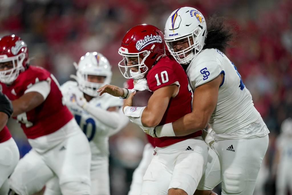 Oct 15, 2022; Fresno, California, USA; Fresno State Bulldogs quarterback Logan Fife (10) is sacked by San Jose State Spartans defensive lineman Viliami Fehoko (42) in the first quarter at Valley Children's Stadium. Credit: Cary Edmondson-USA TODAY Sports