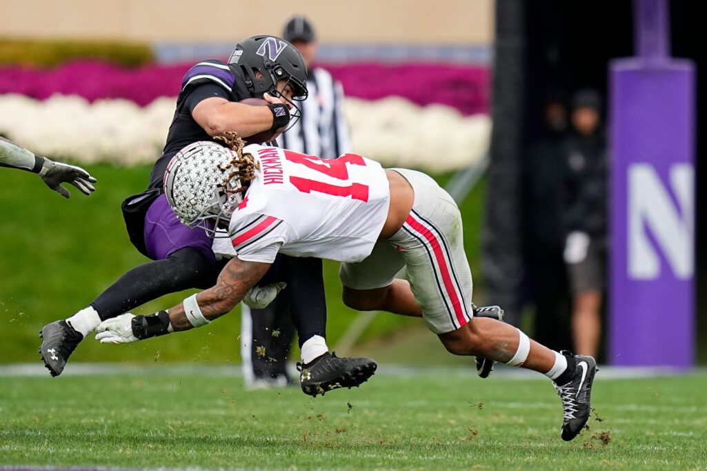 Nov 5, 2022; Evanston, Illinois, USA; Ohio State Buckeyes safety Ronnie Hickman (14) tackles Northwestern Wildcats quarterback Brendan Sullivan (10) during the second half of the NCAA football game at Ryan Field. Ohio State won 21-7. Credit: Adam Cairns-The Columbus Dispatch