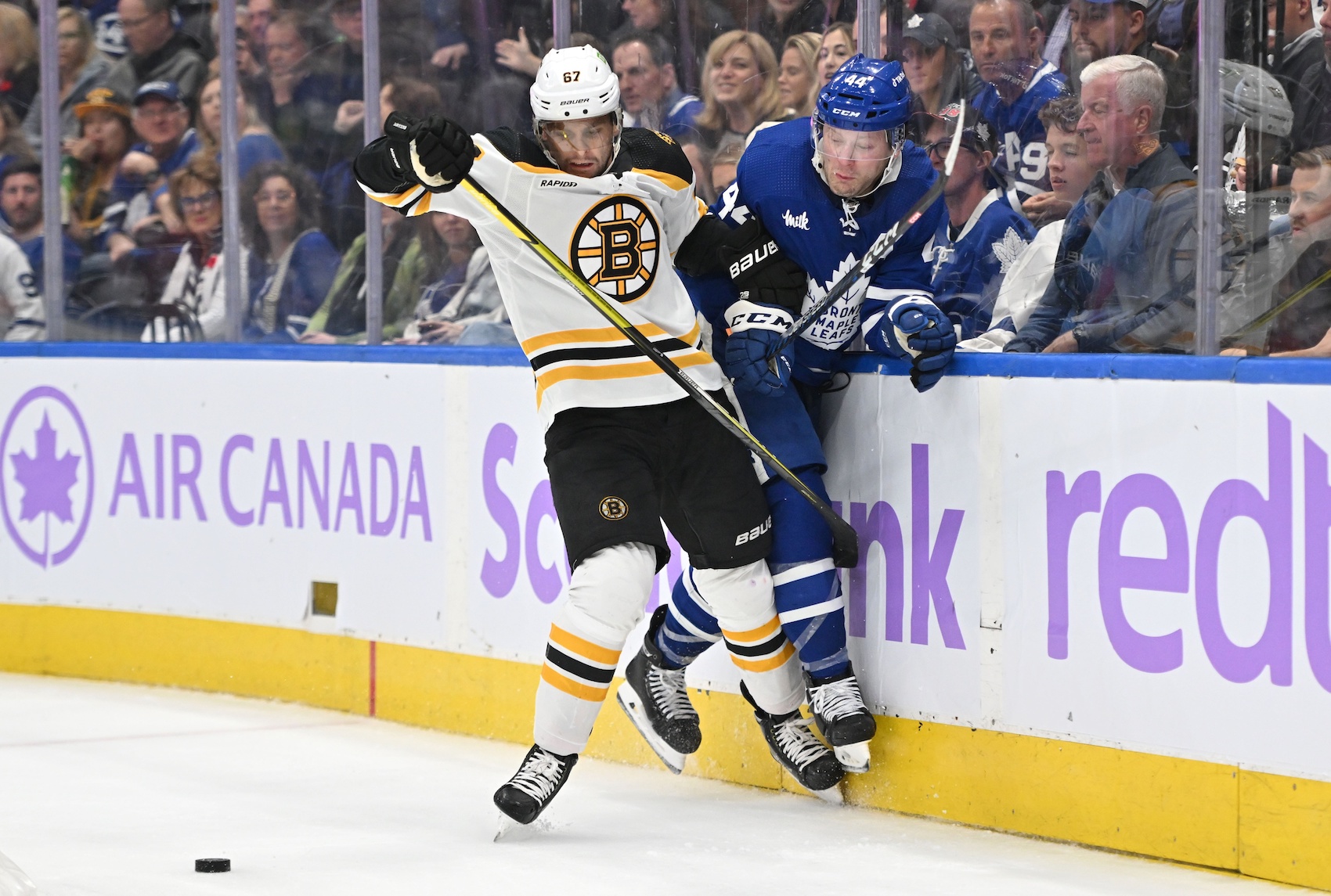 Nov 5, 2022; Toronto, Ontario, CAN; Boston Bruins defenseman Jakub Zboril (67) bodychecks Toronto Maple Leafs defenseman Morgan Rielly (44) in the second period at Scotiabank Arena. Mandatory Credit: Dan Hamilton-USA TODAY Sports