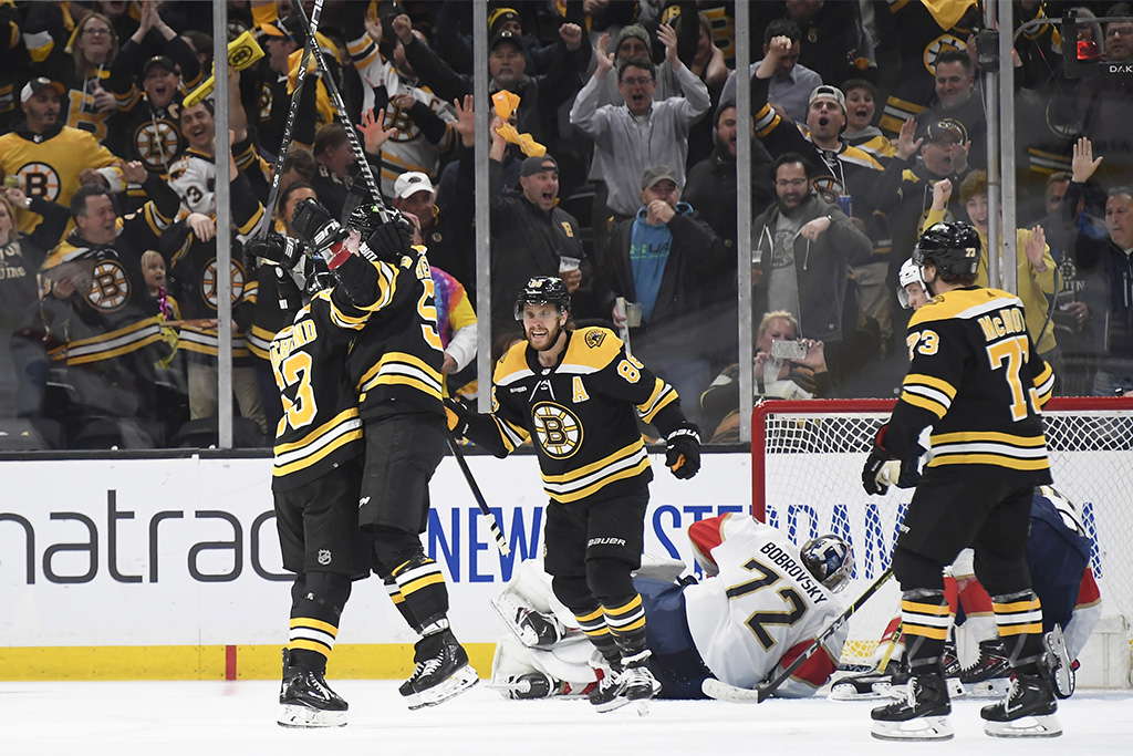 Apr 26, 2023; Boston, Massachusetts, USA; Boston Bruins left wing Brad Marchand (63) reacts with left wing Tyler Bertuzzi (59) after scoring a goal during the second period in game five of the first round of the 2023 Stanley Cup Playoffs against the Florida Panthers at TD Garden. Mandatory Credit: Bob DeChiara-USA TODAY Sports