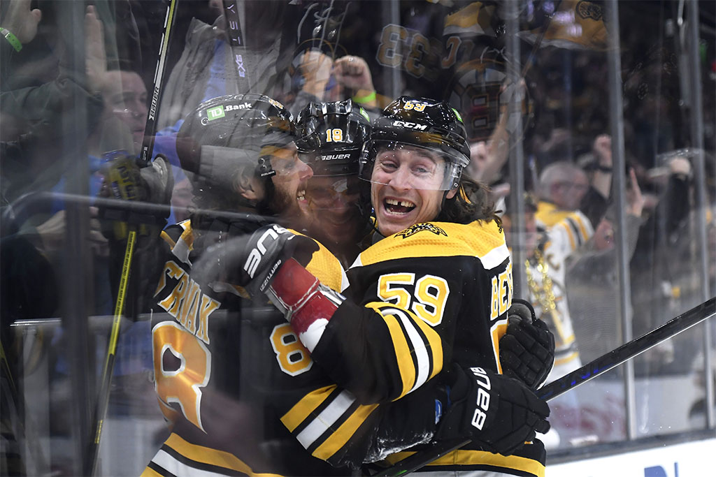 Apr 8, 2023; Boston, Massachusetts, USA; Boston Bruins left wing Tyler Bertuzzi (59) and right wing David Pastrnak (88) celebrate a goal by center Pavel Zacha (18) during the first period against the New Jersey Devils at TD Garden. Mandatory Credit: Bob DeChiara-USA TODAY Sports