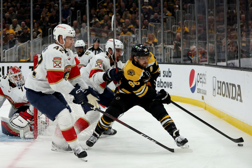 BOSTON, MASSACHUSETTS - APRIL 26: David Pastrnak #88 of the Boston Bruins battles for the puck against Gustav Forsling #42 and Aaron Ekblad #5 of the Florida Panthers during the first period in Game Five of the First Round of the 2023 Stanley Cup Playoffs at TD Garden on April 26, 2023 in Boston, Massachusetts. (Photo by Maddie Meyer/Getty Images)