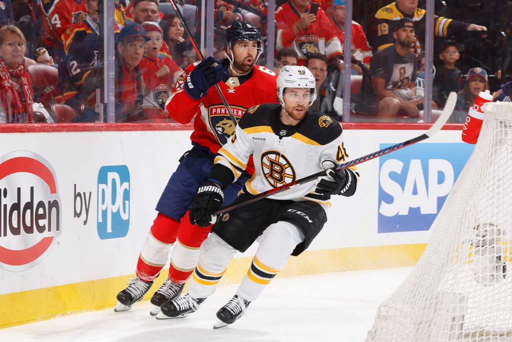 SUNRISE, FL - APRIL 21: Matt Grzelcyk #48 of the Boston Bruins and Colin White #6 of the Florida Panthers circle the net during first period action in Game Three of the First Round of the 2023 Stanley Cup Playoffs at the FLA Live Arena on April 21, 2023 in Sunrise, Florida. (Photo by Joel Auerbach/Getty Images)