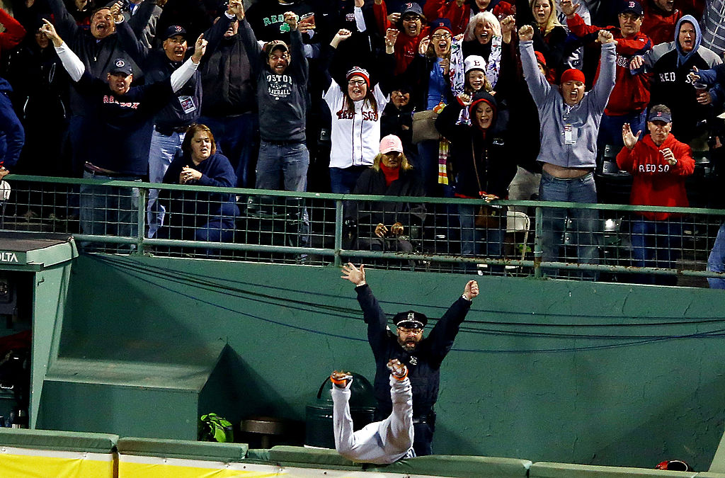 BOSTON, MA - OCTOBER 13: Boston police officer Steve Horgan reacts as Torii Hunter #48 of the Detroit Tigers tries to catch a grand slam hit by David Ortiz #34 of the Boston Red Sox in the eighth inning of Game Two of the American League Championship Series at Fenway Park on October 13, 2013 in Boston, Massachusetts. (Photo by Al Bello/Getty Images)
