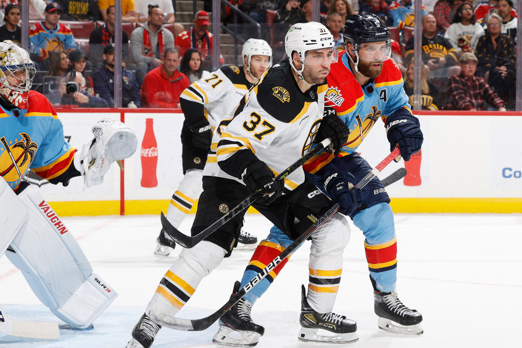 SUNRISE, FL - JANUARY 28: Aaron Ekblad #5 of the Florida Panthers defends against Patrice Bergeron #37 of the Boston Bruins in front of the net during second period action at the FLA Live Arena on January 28, 2023 in Sunrise, Florida. (Photo by Joel Auerbach/Getty Images)