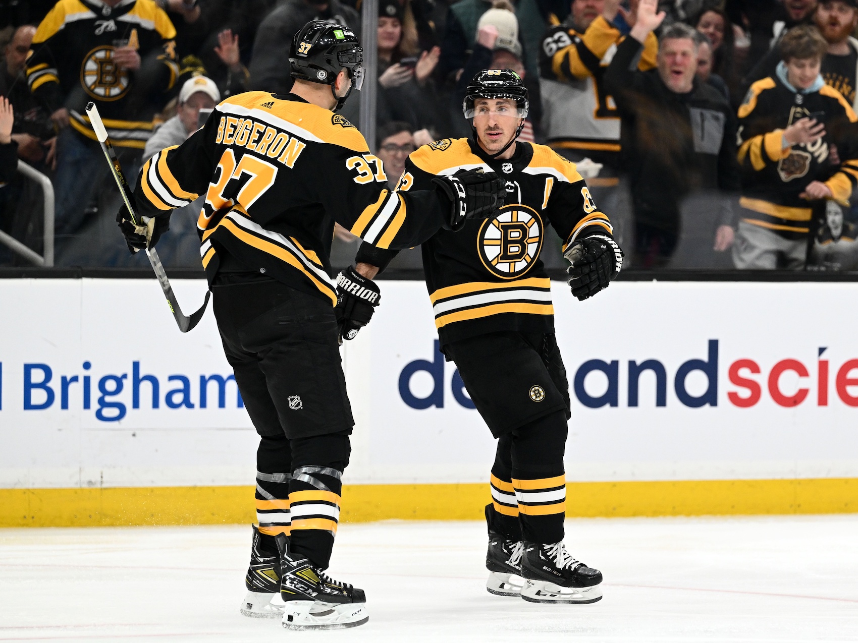 Mar 9, 2023; Boston, Massachusetts, USA; Boston Bruins left wing Brad Marchand (63) celebrates with center Patrice Bergeron (37) after scoring a goal against the Edmonton Oilers during the first period at the TD Garden. Mandatory Credit: Brian Fluharty-USA TODAY Sports