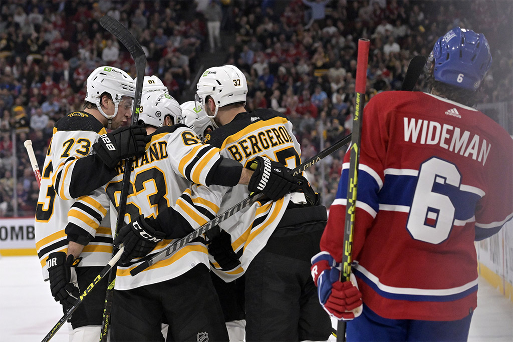 Apr 13, 2023; Montreal, Quebec, CAN; Boston Bruins forward Jake DeBrusk (74) celebrates with teammates including forward Patrice Bergeron (37) and forward Brad Marchand (63) after scoring a goal against the Montreal Canadiens during the first period at the Bell Centre. Mandatory Credit: Eric Bolte-USA TODAY Sports