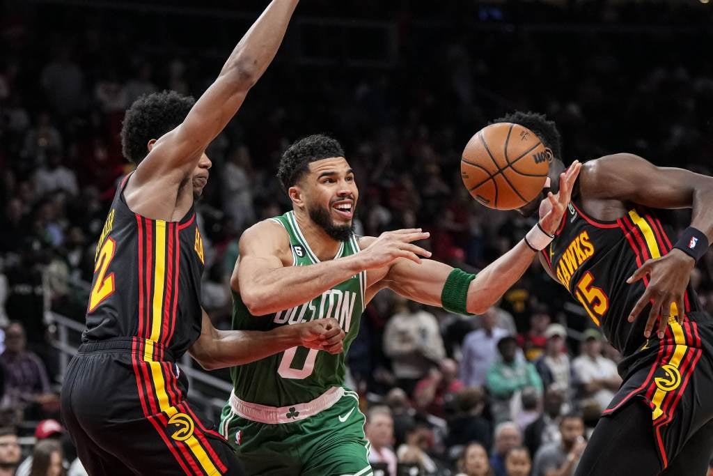 Apr 21, 2023; Atlanta, Georgia, USA; Boston Celtics forward Jayson Tatum (0) tries to control the ball against Atlanta Hawks forward De'Andre Hunter (12) during the first half during game three of the 2023 NBA playoffs at State Farm Arena. Credit: Dale Zanine-USA TODAY Sports