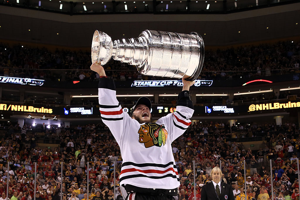 BOSTON, MA - JUNE 24: Jonathan Toews #19 of the Chicago Blackhawks hoist the Stanley Cup Trophy after defeating the Boston Bruins in Game Six of the 2013 NHL Stanley Cup Final at TD Garden on June 24, 2013 in Boston, Massachusetts. The Chicago Blackhawks defeated the Boston Bruins 3-2. (Photo by Bruce Bennett/Getty Images)