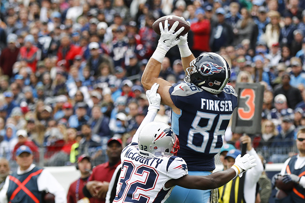 NASHVILLE, TN - NOVEMBER 11: Anthony Firkser #86 of the Tennessee Titans jumps to catch a pass from Marcus Mariota #8 while defended by Devin McCourty #32 of the New England Patriots during the second quarter at Nissan Stadium on November 11, 2018 in Nashville, Tennessee. (Photo by Wesley Hitt/Getty Images)