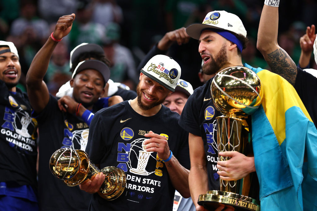 BOSTON, MASSACHUSETTS - JUNE 16: Stephen Curry #30 and Klay Thompson #11 of the Golden State Warriors celebrate after defeating the Boston Celtics 103-90 in Game Six of the 2022 NBA Finals at TD Garden on June 16, 2022 in Boston, Massachusetts. (Photo by Elsa/Getty Images)