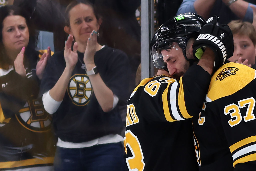 BOSTON, MASSACHUSETTS - APRIL 30: Patrice Bergeron #37 of the Boston Bruins hugs Brad Marchand #63 before exiting the ice after Florida Panthers defeat the Bruins 4-3 in overtime of Game Seven of the First Round of the 2023 Stanley Cup Playoffs at TD Garden on April 30, 2023 in Boston, Massachusetts. (Photo by Maddie Meyer/Getty Images)