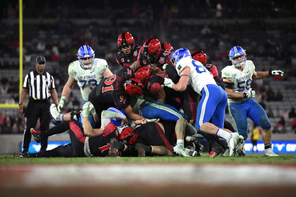 Nov 26, 2022; San Diego, California, USA; Air Force Falcons running back Brad Roberts (20) is tackled by San Diego State Aztecs defensive lineman Justus Tavai (91) during the second half at Snapdragon Stadium. Credit: Orlando Ramirez-USA TODAY Sports
