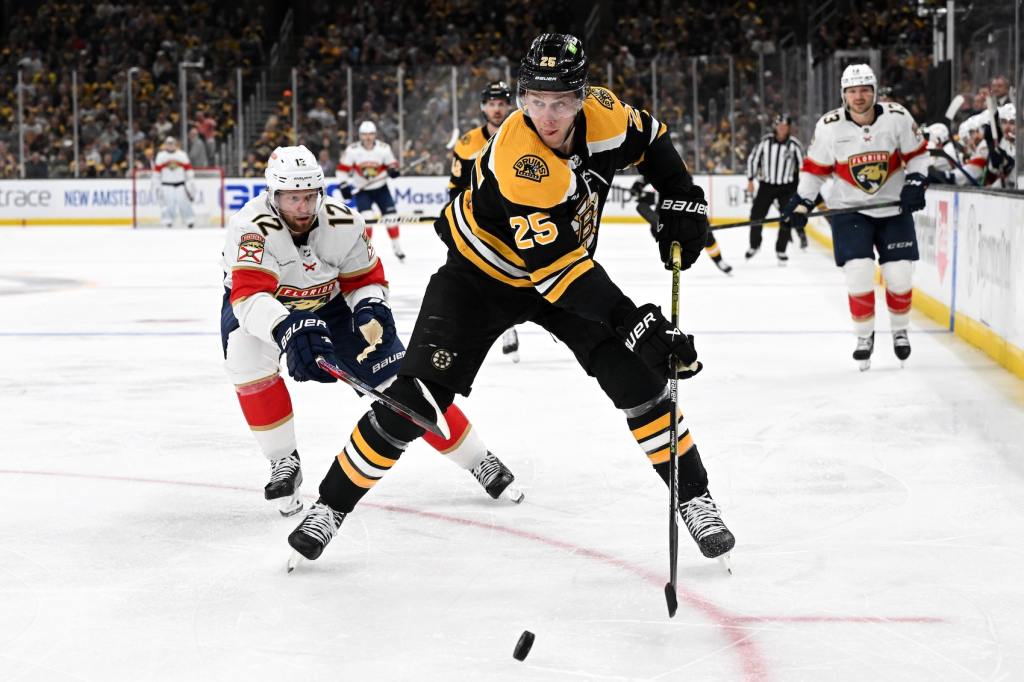 Apr 17, 2023; Boston, Massachusetts, USA; Boston Bruins defenseman Brandon Carlo (25) controls the puck against Florida Panthers center Eric Staal (12) during the third period of game one of the first round of the 2023 Stanley Cup Playoffs at TD Garden. Mandatory Credit: Brian Fluharty-USA TODAY Sports