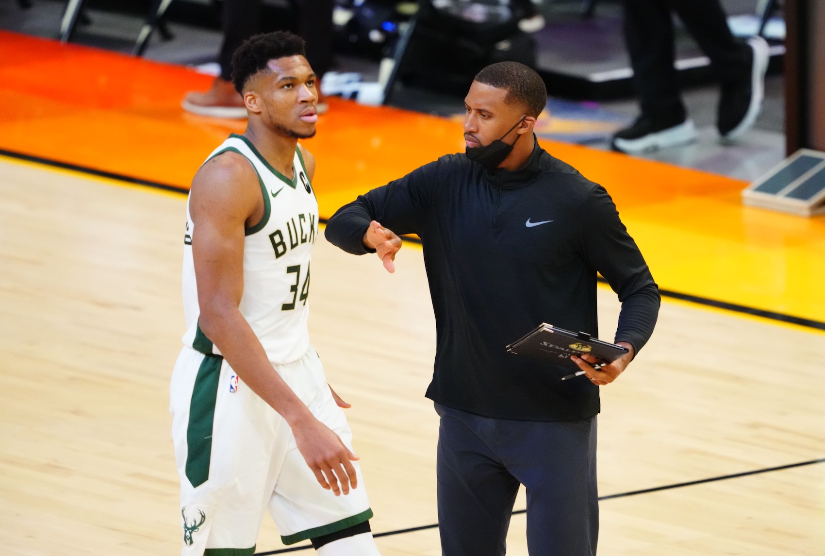 Jul 6, 2021; Phoenix, Arizona, USA; Milwaukee Bucks forward Giannis Antetokounmpo (34) with assistant coach Charles Lee against the Phoenix Suns in game one of the 2021NBA Finals at Phoenix Suns Arena. Mandatory Credit: Mark J. Rebilas-USA TODAY Sports