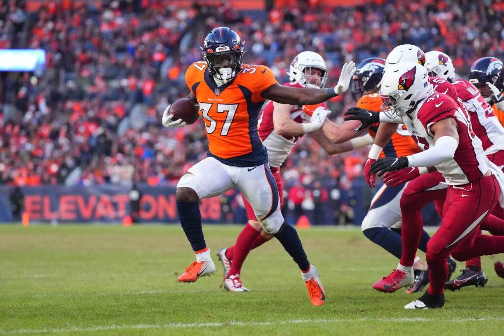 Dec 18, 2022; Denver, Colorado, USA; Denver Broncos running back Marlon Mack (37) carries the ball for a touchdown past Arizona Cardinals linebacker Ezekiel Turner (47) in the second half at Empower Field at Mile High. Credit: Ron Chenoy-USA TODAY Sports