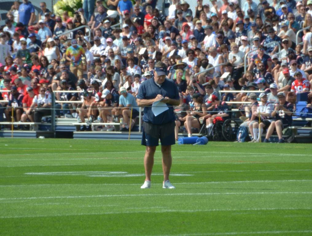 Bill Belichick writes down a note during Patriots training camp practice. (Alex Barth/98.5 The Sports Hub)