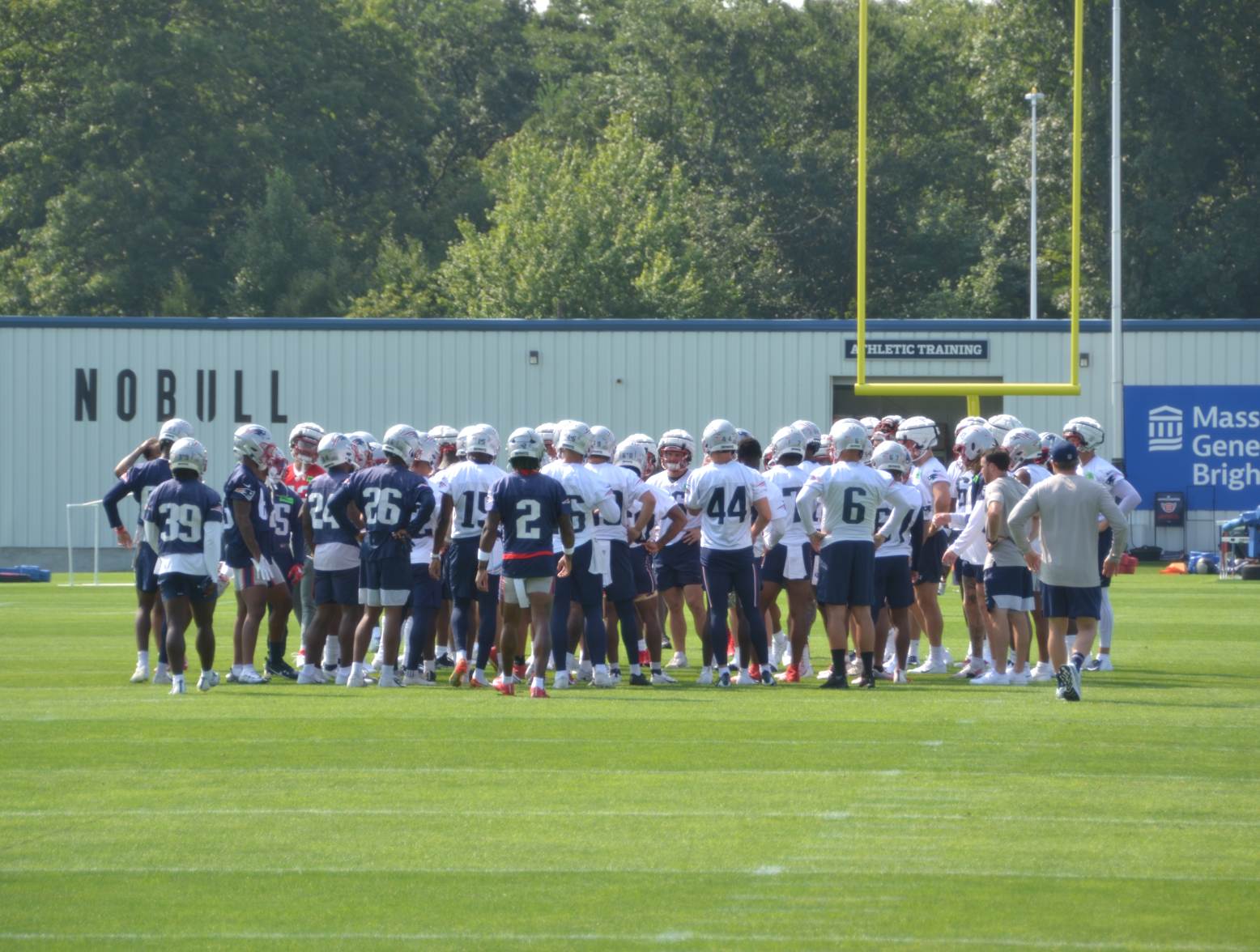 The Patriots huddle up before their first training camp practice of 2023 (Alex Barth/98.5 The Sports Hub)