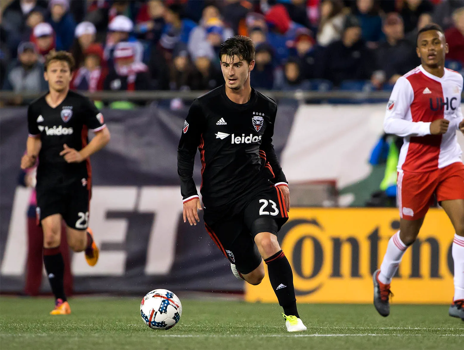 Apr 22, 2017; Foxborough, MA, USA; D.C. United midfielder Ian Harkes (23) carries the ball past New England Revolution forward Juan Agudelo (17) during the second half of their 2-2 tie at Gillette Stadium. Mandatory Credit: Winslow Townson-USA TODAY Sports
