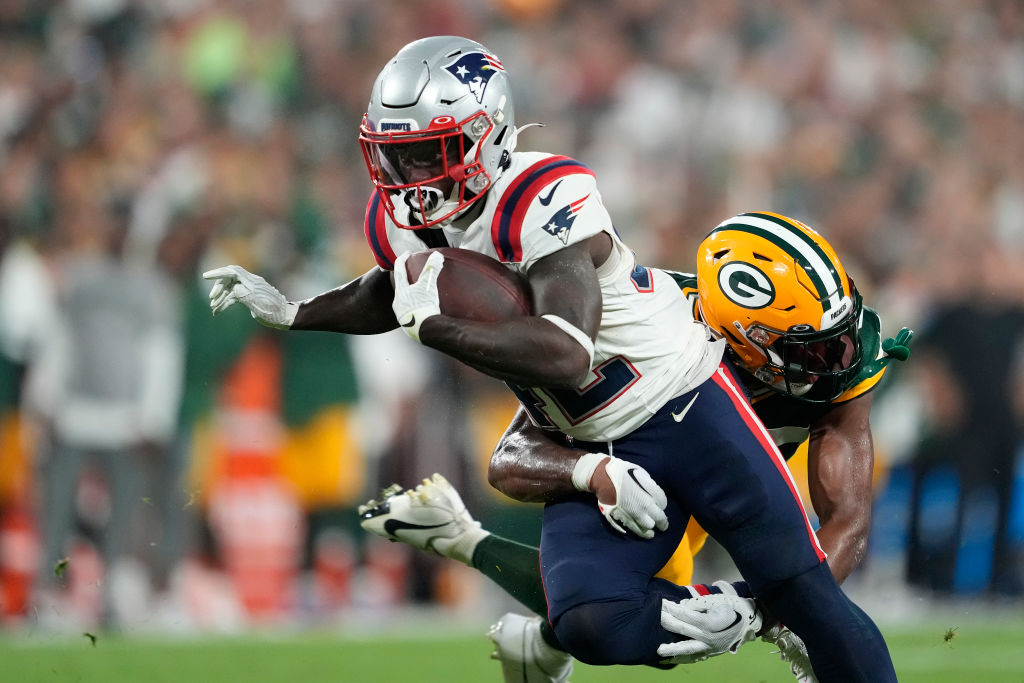 GREEN BAY, WISCONSIN - AUGUST 19: Anthony Johnson Jr. #36 of the Green Bay Packers tackles J.J. Taylor #42 of the New England Patriots in the second half during a preseason game at Lambeau Field on August 19, 2023 in Green Bay, Wisconsin. (Photo by Patrick McDermott/Getty Images)