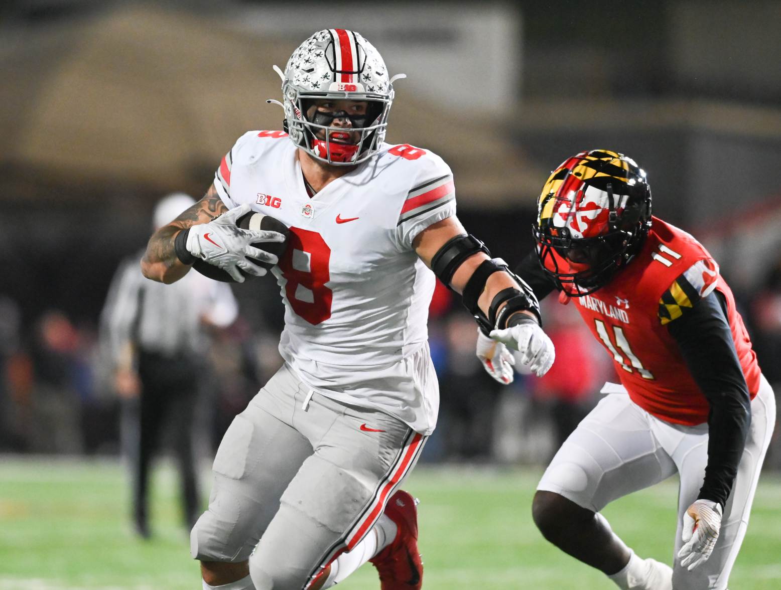 Nov 19, 2022; College Park, Maryland, USA; Ohio State Buckeyes tight end Cade Stover (8) runs after the catch as Maryland Terrapins linebacker Ruben Hyppolite II (11) defends during there second half at SECU Stadium. Credit: Tommy Gilligan-USA TODAY Sports