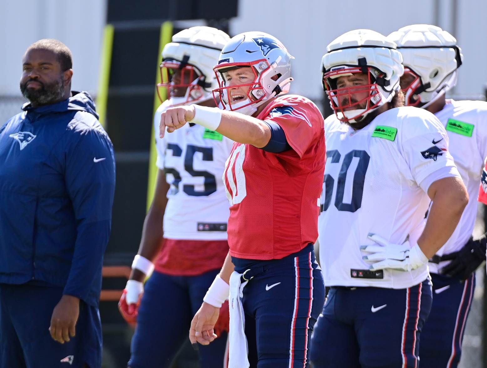 Aug 1, 2023; Foxborough, MA, USA; New England Patriots quarterback Mac Jones (10) directs the offense before doing a drill at training camp at Gillette Stadium. Credit: Eric Canha-USA TODAY Sports