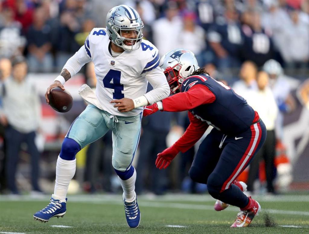 FOXBOROUGH, MASSACHUSETTS - OCTOBER 17: Dak Prescott #4 of the Dallas Cowboys scrambles with the ball against Jaylon Smith #9 of the Dallas Cowboys in the first half at Gillette Stadium on October 17, 2021 in Foxborough, Massachusetts. (Photo by Maddie Meyer/Getty Images)