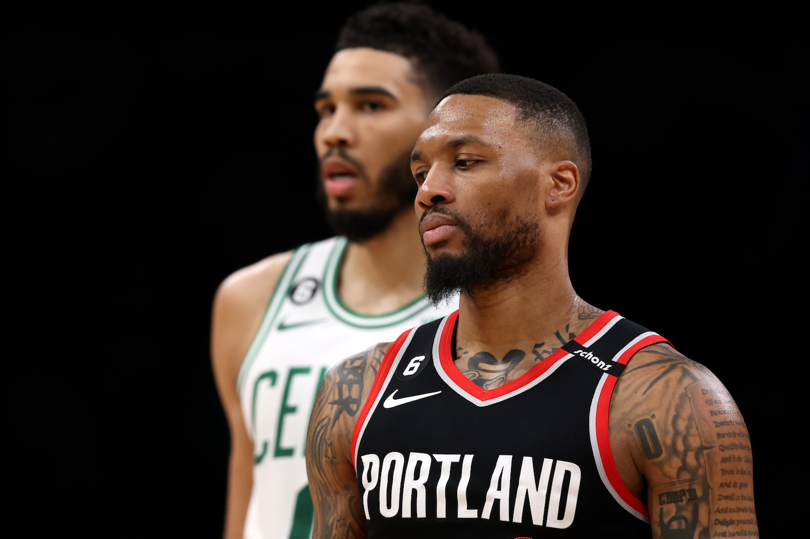 BOSTON, MASSACHUSETTS - MARCH 08:  Damian Lillard #0 of the Portland Trail Blazers looks on with Jayson Tatum #0 of the Boston Celtics at TD Garden on March 08, 2023 in Boston, Massachusetts. The Celtics defeat the Trail Blazers 115-93. NOTE TO USER: User expressly acknowledges and agrees that, by downloading and or using this photograph, User is consenting to the terms and conditions of the Getty Images License Agreement. (Maddie Meyer/Getty Images)