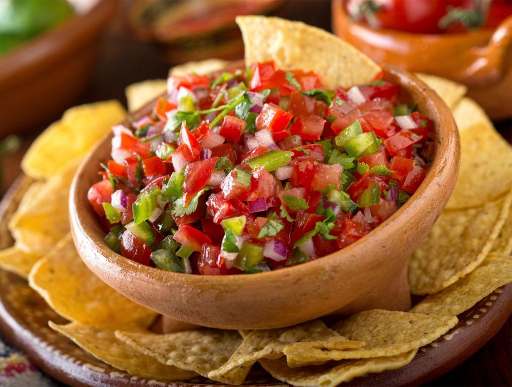 A delicious home made salsa pico de gallo with tomato, red onion, lime, cilantro, and jalapeno pepper.