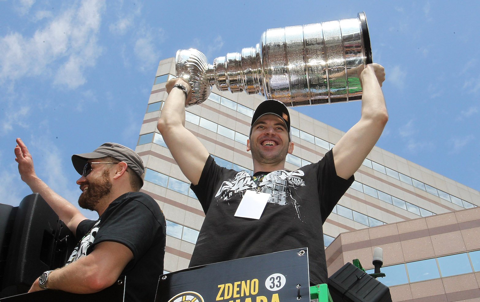 BOSTON, MA - JUNE 18:Tim Thomas and Zdeno Chara, both of the Boston Bruins, reacts to cheers a Stanley Cup victory parade on June 18, 2011 in Boston, Massachusetts. (Photo by Jim Rogash/Getty Images)