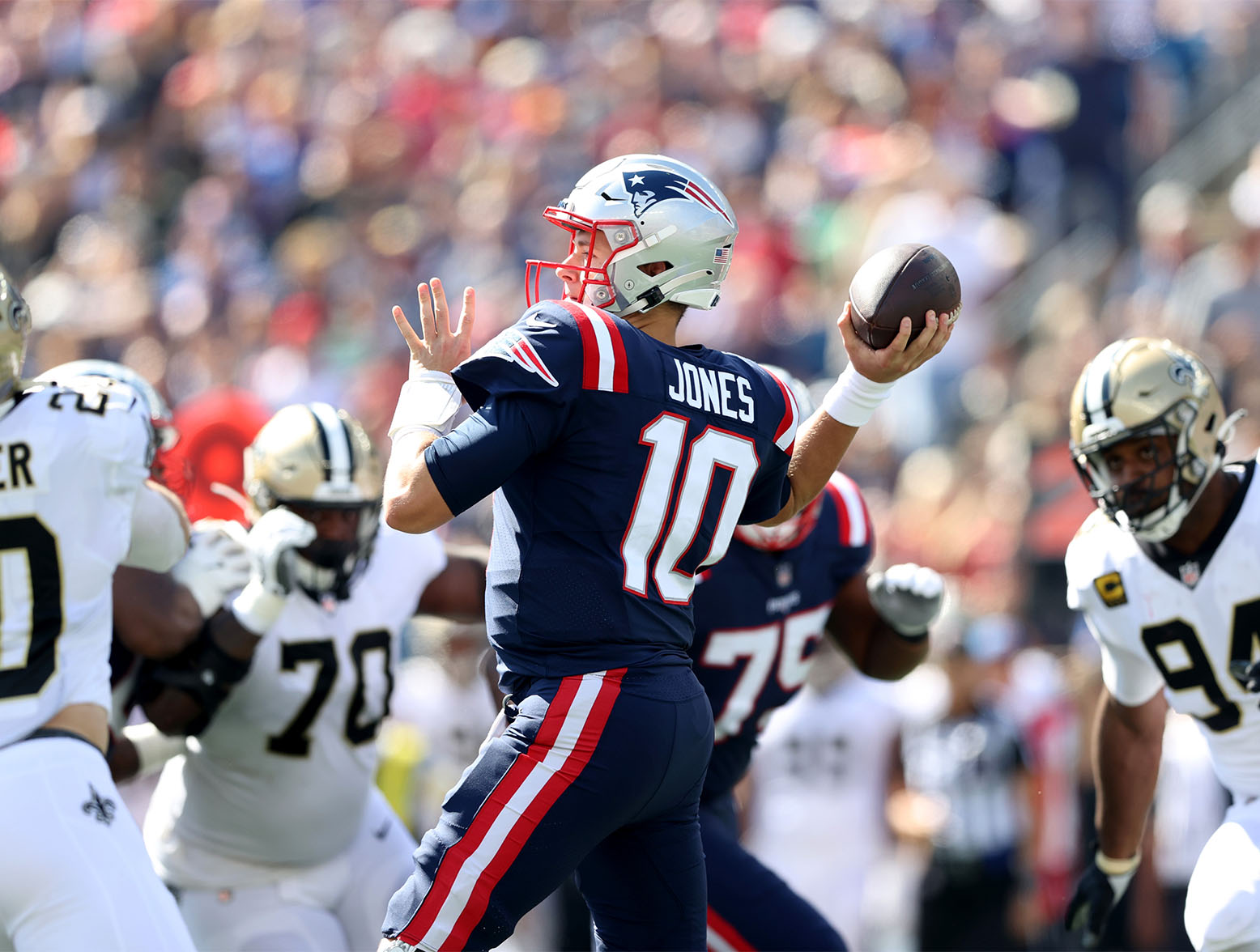FOXBOROUGH, MASSACHUSETTS - SEPTEMBER 26: Quarterback Mac Jones #10 of the New England Patriots passes the ball against the New Orleans Saints in the first quarter of the game at Gillette Stadium on September 26, 2021 in Foxborough, Massachusetts. (Photo by Elsa/Getty Images)