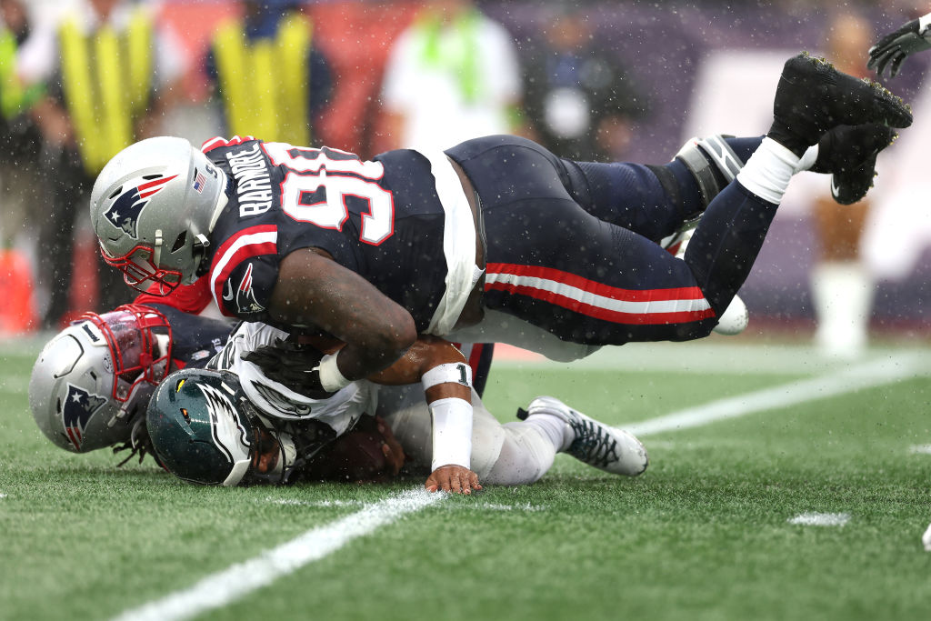 FOXBOROUGH, MASSACHUSETTS - SEPTEMBER 10: Matthew Judon #9 of the New England Patriots and Christian Barmore #90 of the New England Patriots sack Jalen Hurts #1 of the Philadelphia Eagles during the first quarter at Gillette Stadium on September 10, 2023 in Foxborough, Massachusetts. (Photo by Maddie Meyer/Getty Images)