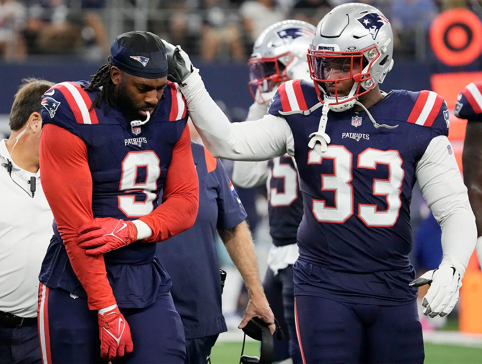 ARLINGTON, TEXAS - OCTOBER 01: Matthew Judon #9 of the New England Patriots holds his arm while walking off the field while consoled by Anfernee Jennings #33 of the New England Patriots during the third quarter against the Dallas Cowboys at AT&T Stadium on October 01, 2023 in Arlington, Texas. (Photo by Sam Hodde/Getty Images)