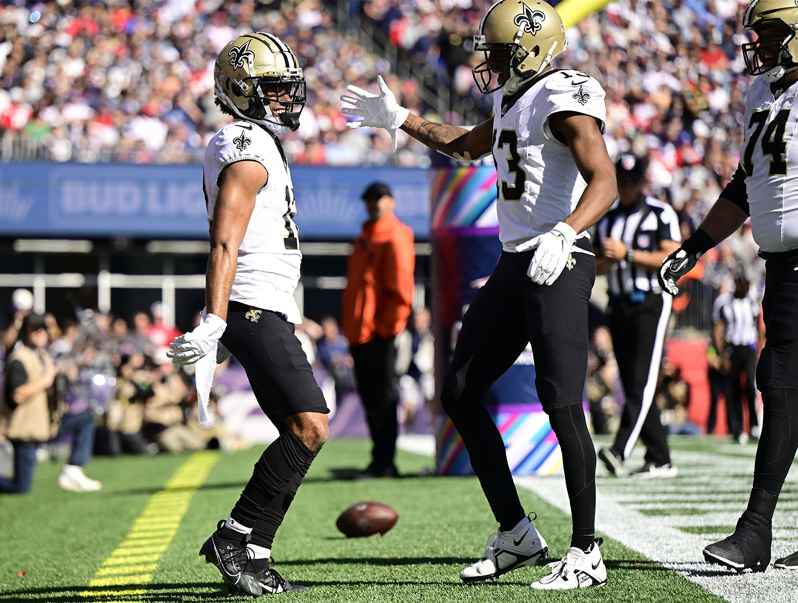 FOXBOROUGH, MASSACHUSETTS - OCTOBER 08: Chris Olave #12 of the New Orleans Saints celebrates his receiving touchdown with Michael Thomas #13 of the New Orleans Saints during the second quarter against the New England Patriots at Gillette Stadium on October 08, 2023 in Foxborough, Massachusetts. (Photo by Maddie Malhotra/Getty Images)