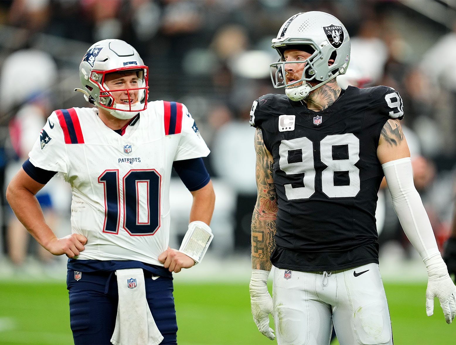 LAS VEGAS, NEVADA - OCTOBER 15: Mac Jones #10 of the New England Patriots laughs while Maxx Crosby #98 of the Las Vegas Raiders reacts after flag during the first half at Allegiant Stadium on October 15, 2023 in Las Vegas, Nevada. (Photo by Chris Unger/Getty Images)