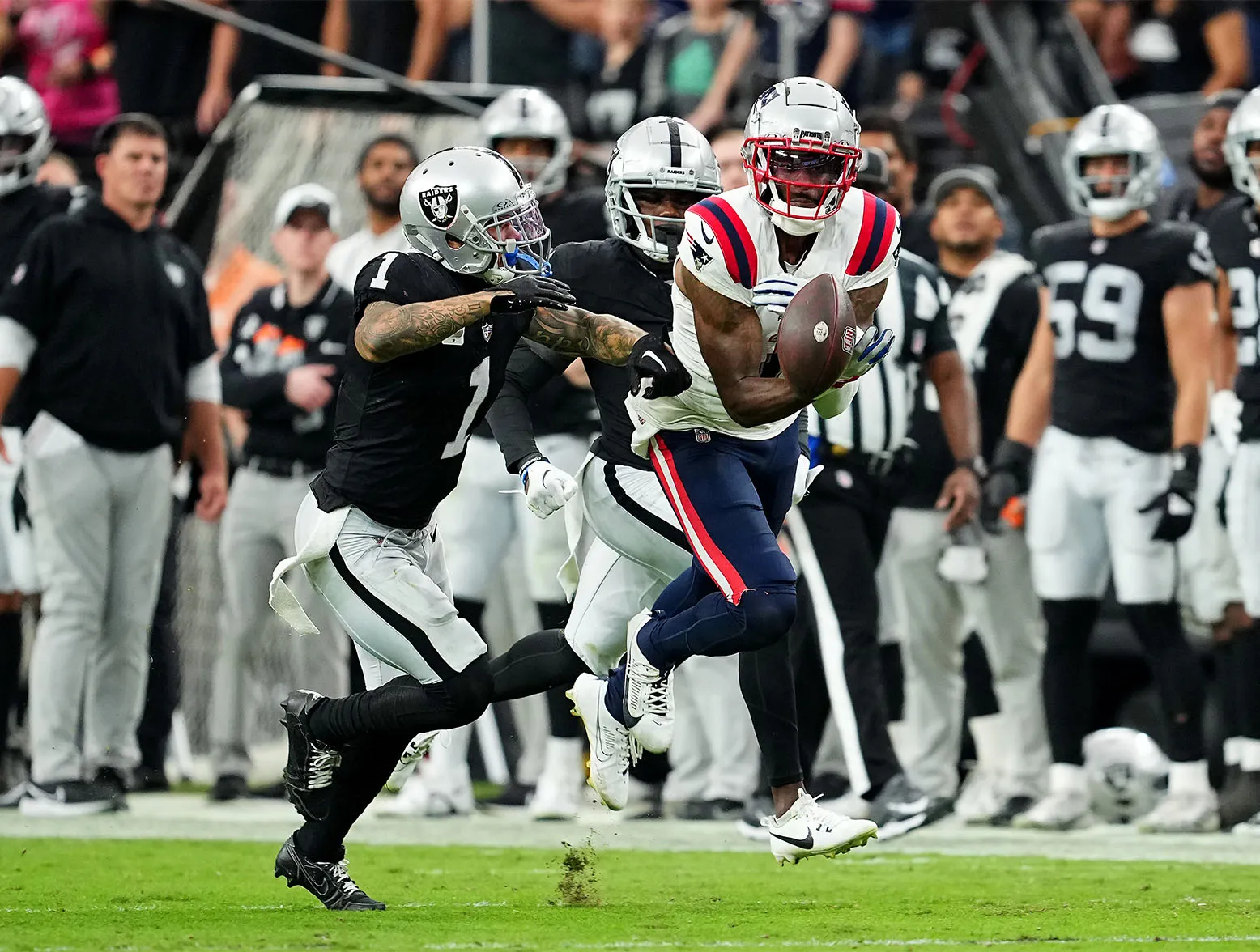 LAS VEGAS, NEVADA - OCTOBER 15: DeVante Parker #1 of the New England Patriots drops a pass while defended by Marcus Epps #1 of the Las Vegas Raiders during the fourth quarter at Allegiant Stadium on October 15, 2023 in Las Vegas, Nevada. (Photo by Chris Unger/Getty Images)