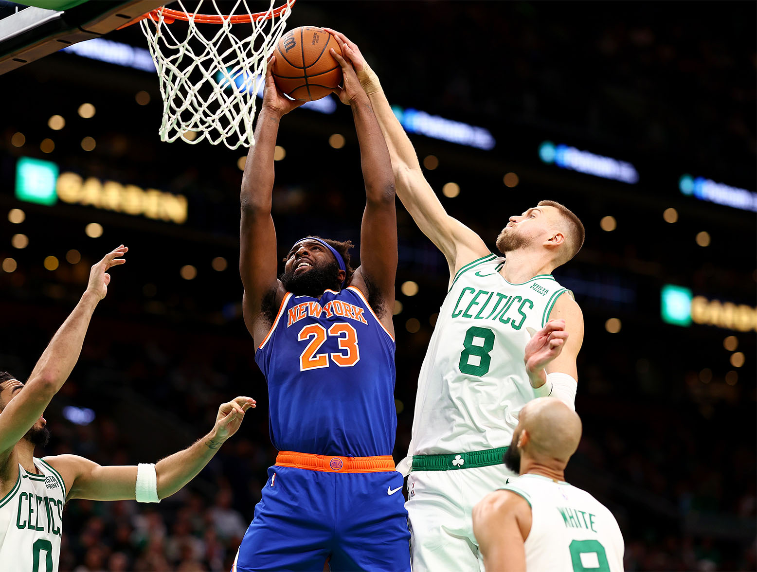BOSTON, MASSACHUSETTS - OCTOBER 17: Kristaps Porzingis #8 of the Boston Celtics blocks a shot from Mitchell Robinson #23 of the New York Knicks during the second quarter of the preseason game at TD Garden on October 17, 2023 in Boston, Massachusetts. NOTE TO USER: User expressly acknowledges and agrees that, by downloading and or using this photograph, User is consenting to the terms and conditions of the Getty Images License Agreement. (Photo by Maddie Meyer/Getty Images)