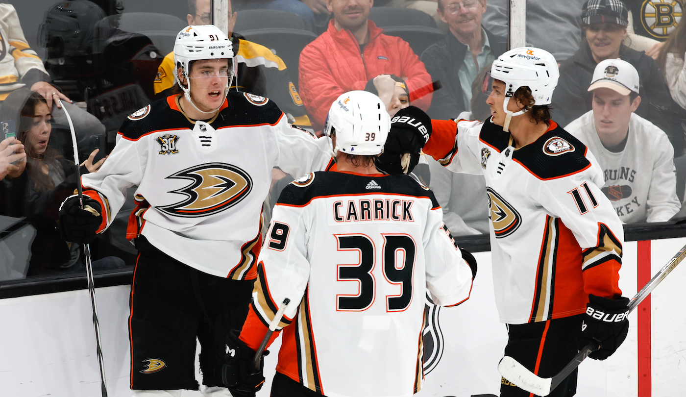 BOSTON, MASSACHUSETTS - OCTOBER 26: Leo Carlsson #91 of the Anaheim Ducks celebrates his goal in the final minutes of regulation to pull the Ducks within a goal at 3-2 with his teammates Trevor Zegras #11 and Sam Carrick #39 against the Boston Bruins at the TD Garden on October 26, 2023 in Boston, Massachusetts. (Photo by Rich Gagnon/Getty Images) *** Local Caption *** Leo Carlsson;Trevor Zegras;Sam Carrick