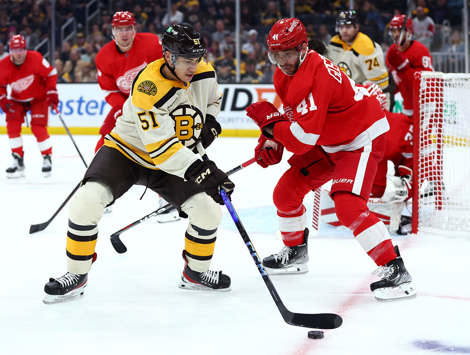 BOSTON, MASSACHUSETTS - OCTOBER 28: Matthew Poitras #51 of the Boston Bruins looks for a shot against Shayne Gostisbehere #41 of the Detroit Red Wings during the first period at TD Garden on October 28, 2023 in Boston, Massachusetts. (Photo by Maddie Meyer/Getty Images)