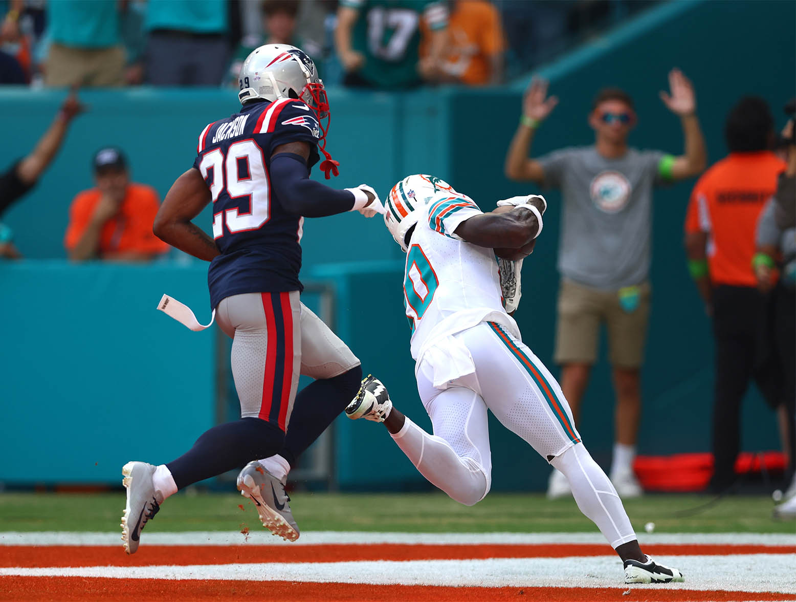 MIAMI GARDENS, FLORIDA - OCTOBER 29: Tyreek Hill #10 of the Miami Dolphins catches a touchdown over J.C. Jackson #29 of the New England Patriots during the first quarter at Hard Rock Stadium on October 29, 2023 in Miami Gardens, Florida. (Photo by Megan Briggs/Getty Images)