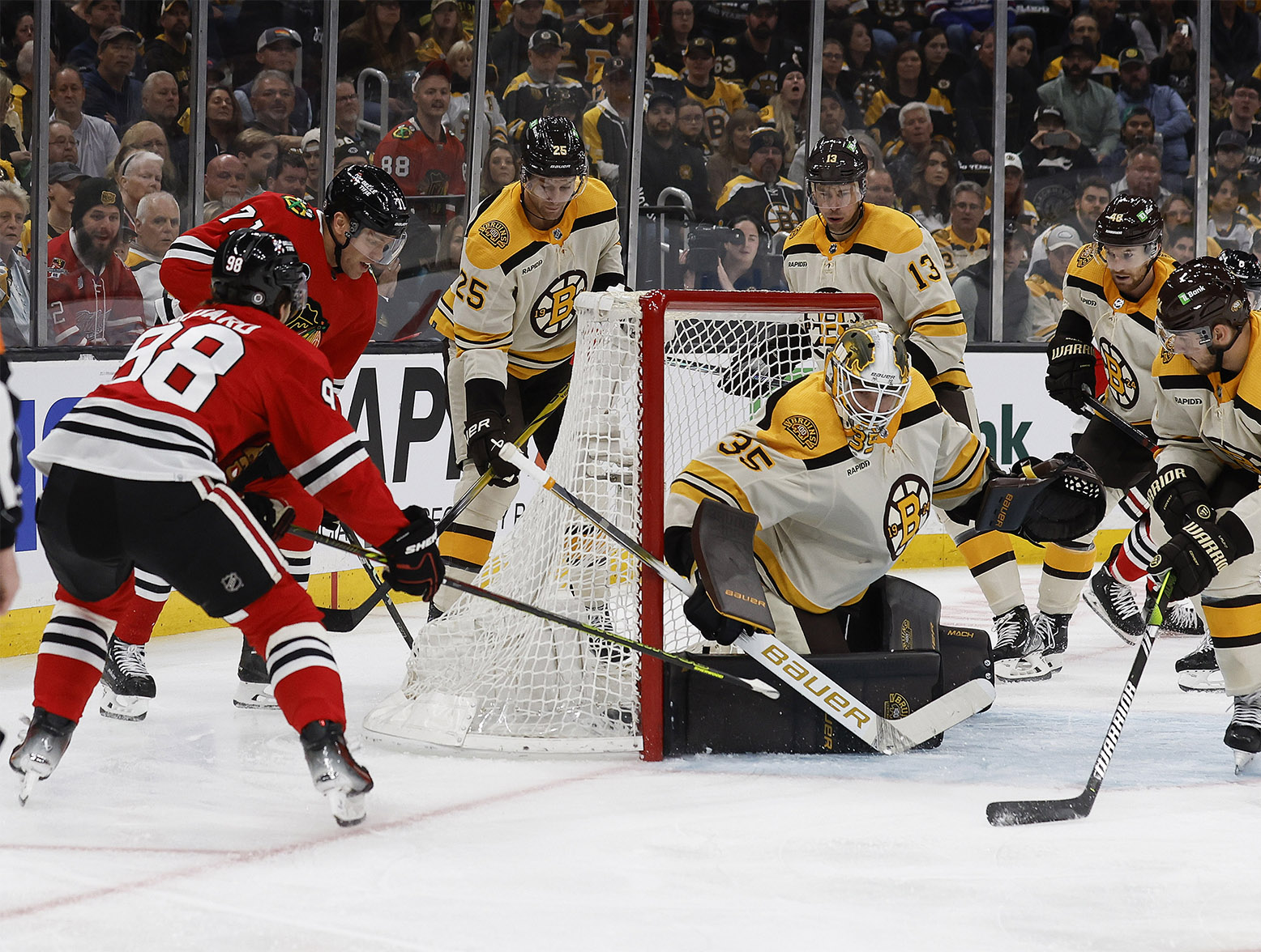 Oct 11, 2023; Boston, Massachusetts, USA; Chicago Blackhawks center Connor Bedard (98) stuffs home his first NHL goal on Boston Bruins goaltender Linus Ullmark (35) during the first period at TD Garden. Mandatory Credit: Winslow Townson-USA TODAY Sports