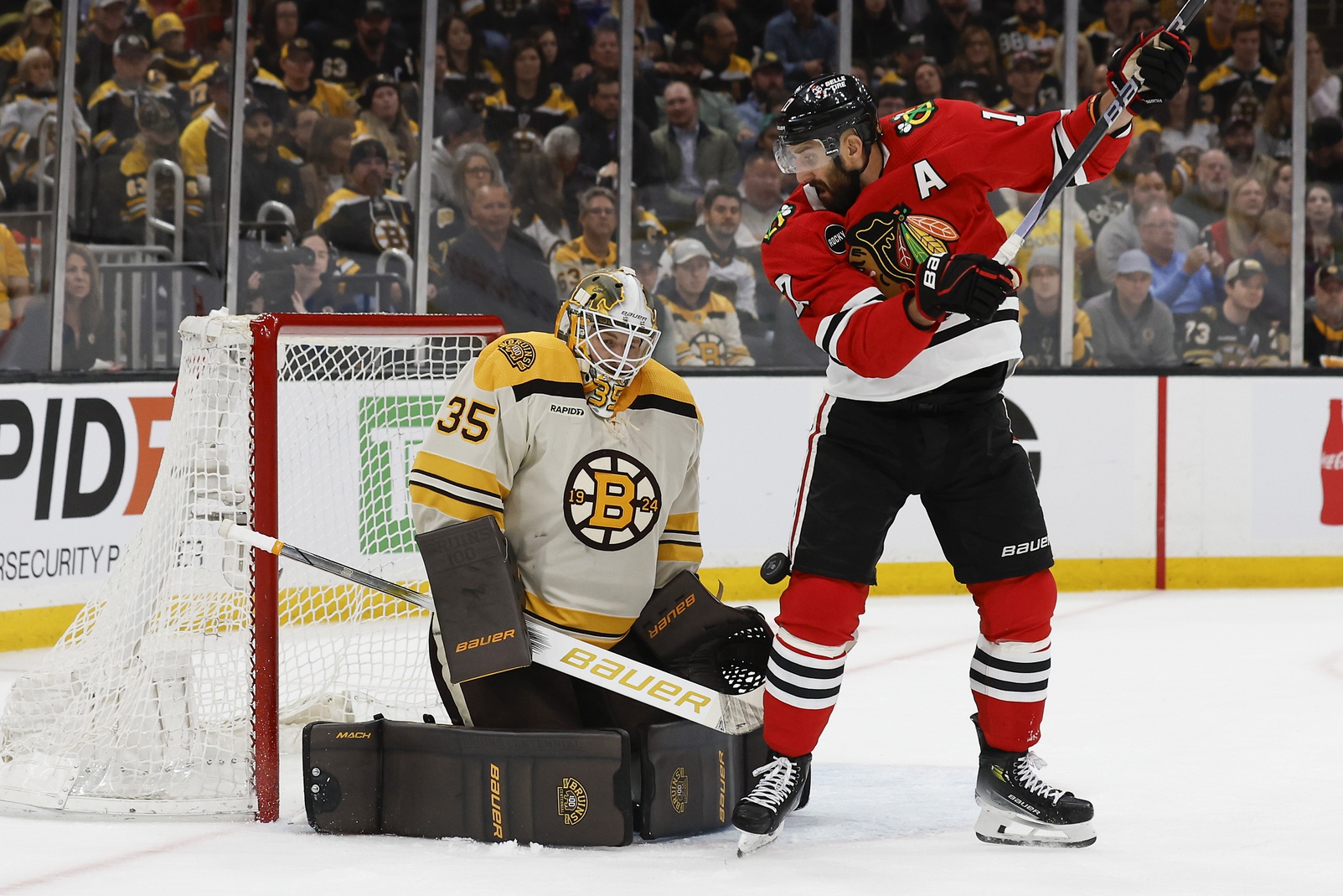Oct 11, 2023; Boston, Massachusetts, USA; Boston Bruins goaltender Linus Ullmark (35) makes a save as Chicago Blackhawks left wing Nick Foligno (17) looks for the rebound during the first period at TD Garden. Mandatory Credit: Winslow Townson-USA TODAY Sports