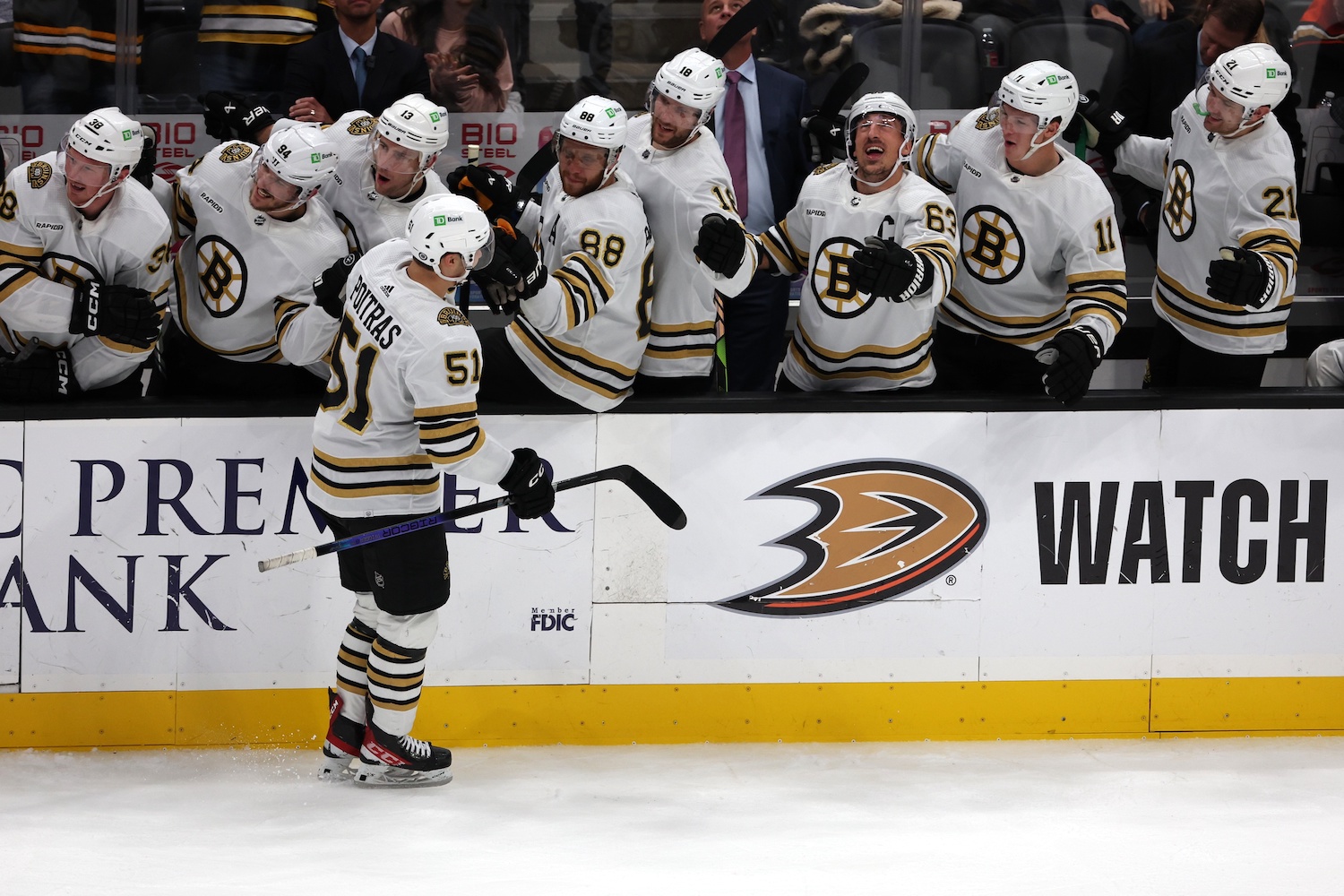 Oct 22, 2023; Anaheim, California, USA; Boston Bruins center Matthew Poitras (51) celebrates with teammates after scoring a game tying goal during the third period against the Anaheim Ducks at Honda Center. Mandatory Credit: Kiyoshi Mio-USA TODAY Sports