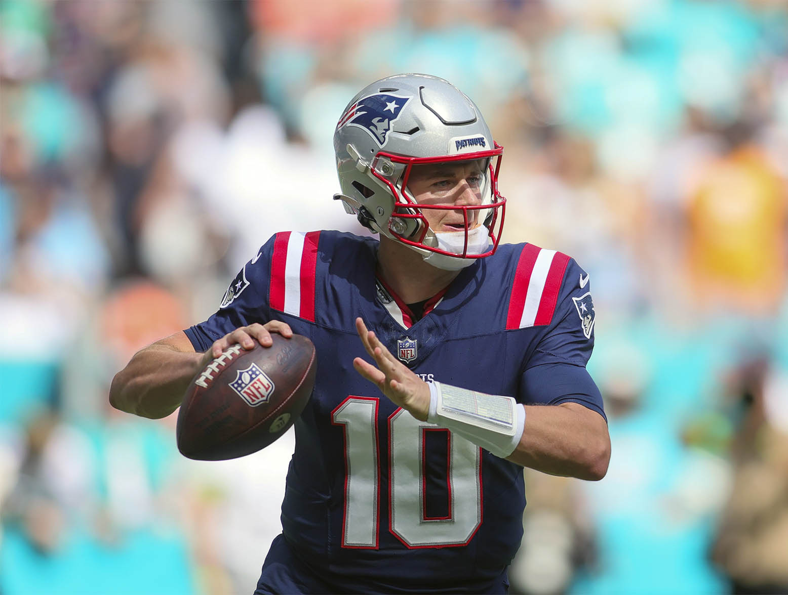 Oct 29, 2023; Miami Gardens, Florida, USA; New England Patriots quarterback Mac Jones (10) looks for a passing option against the Miami Dolphins during the first quarter at Hard Rock Stadium. Mandatory Credit: Sam Navarro-USA TODAY Sports