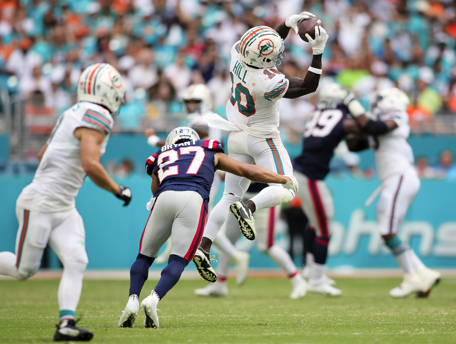 Oct 29, 2023; Miami Gardens, Florida, USA; Miami Dolphins wide receiver Tyreek Hill (10) catches the football against New England Patriots cornerback Myles Bryant (27) during the fourth quarter at Hard Rock Stadium. Mandatory Credit: Sam Navarro-USA TODAY Sports