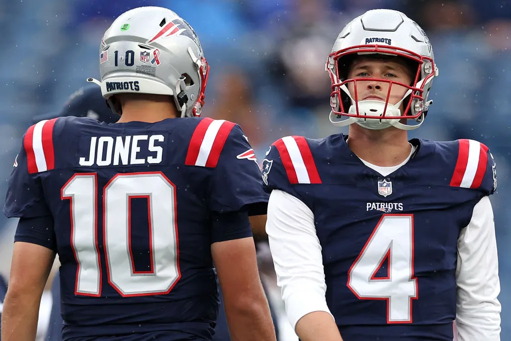 FOXBOROUGH, MASSACHUSETTS - SEPTEMBER 10: Bailey Zappe #4 of the New England Patriots looks on next to Mac Jones #10 before the game against the Philadelphia Eagles at Gillette Stadium on September 10, 2023 in Foxborough, Massachusetts. (Photo by Maddie Meyer/Getty Images)