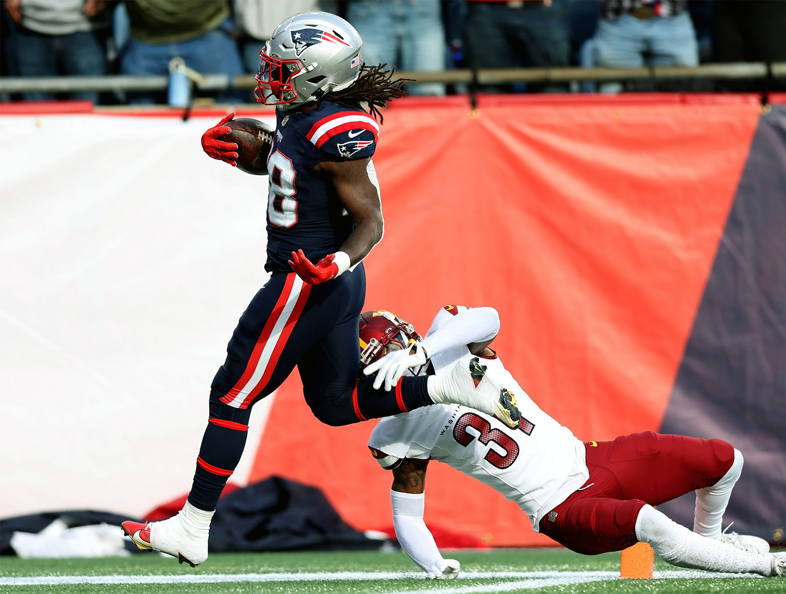 FOXBOROUGH, MASSACHUSETTS - NOVEMBER 05: Rhamondre Stevenson #38 of the New England Patriots scores a touchdown during the first half in the game against the Washington Commanders at Gillette Stadium on November 05, 2023 in Foxborough, Massachusetts. (Photo by Adam Glanzman/Getty Images)