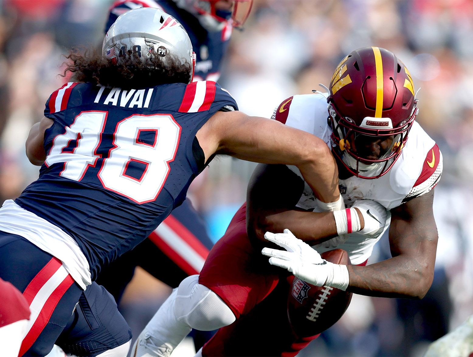 FOXBOROUGH, MASSACHUSETTS - NOVEMBER 05: Brian Robinson Jr. #8 of the Washington Commanders fumbles the ball during the first half in the game against the New England Patriots at Gillette Stadium on November 05, 2023 in Foxborough, Massachusetts. (Photo by Adam Glanzman/Getty Images)