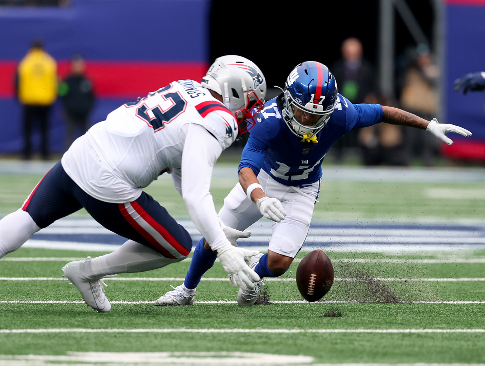 EAST RUTHERFORD, NEW JERSEY - NOVEMBER 26: Anfernee Jennings #33 of the New England Patriots and Wan'Dale Robinson #17 of the New York Giants attempt to recover a fumble during the first quarter at MetLife Stadium on November 26, 2023 in East Rutherford, New Jersey. (Photo by Al Bello/Getty Images)